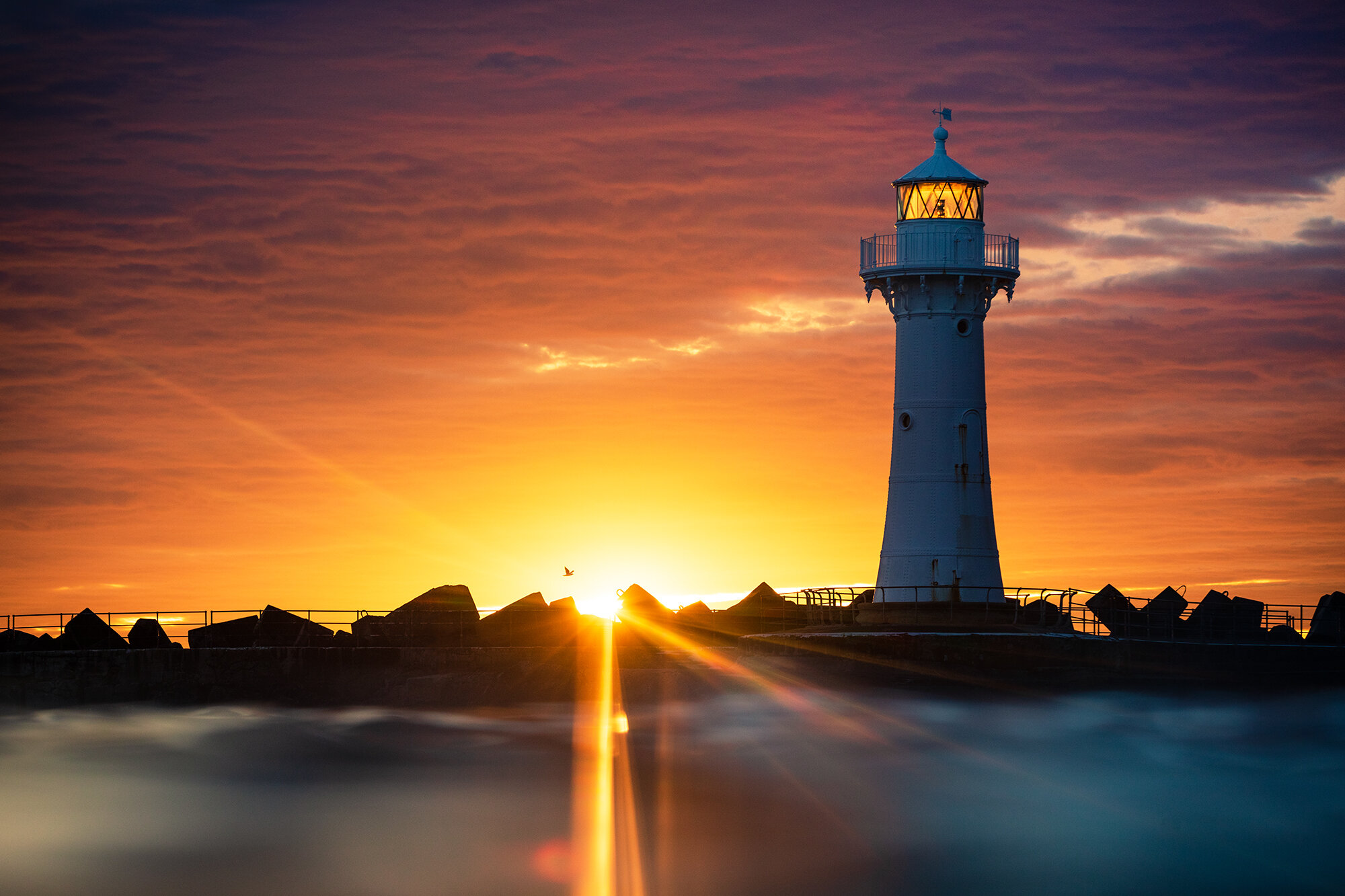 AWAKENING - I've lived in Wollongong for the best part of a decade and only a stones through from Belmore Basin which boasts one of the only promenades on the East Coast two feature two lighthouses. Neither of these are currently functional but they are considered an iconic feature of Wollongong and the surrounding region. As I type this, we are currently entering a third month of lockdown and with travel restrictions in place I made a decision to focus on and make new seascapes of the local area. This is one of my many attempts at interpreting something that's been shot a million times, and then some. Wollongong's Breakwater Lighthouse captured on sunrise from the ocean's surface.